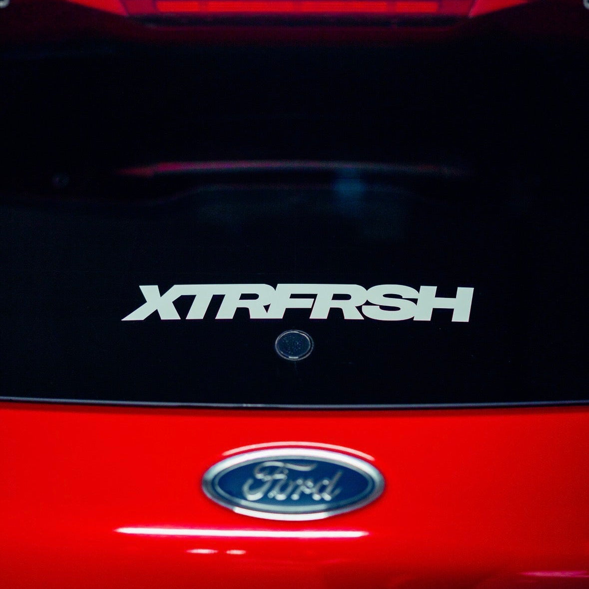 XTRFRSH bold sticker on a car window.