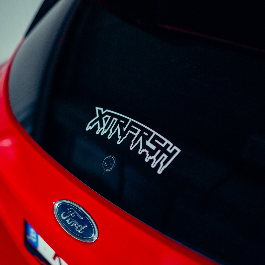 XTRFRSH OG drip sticker on a car window.