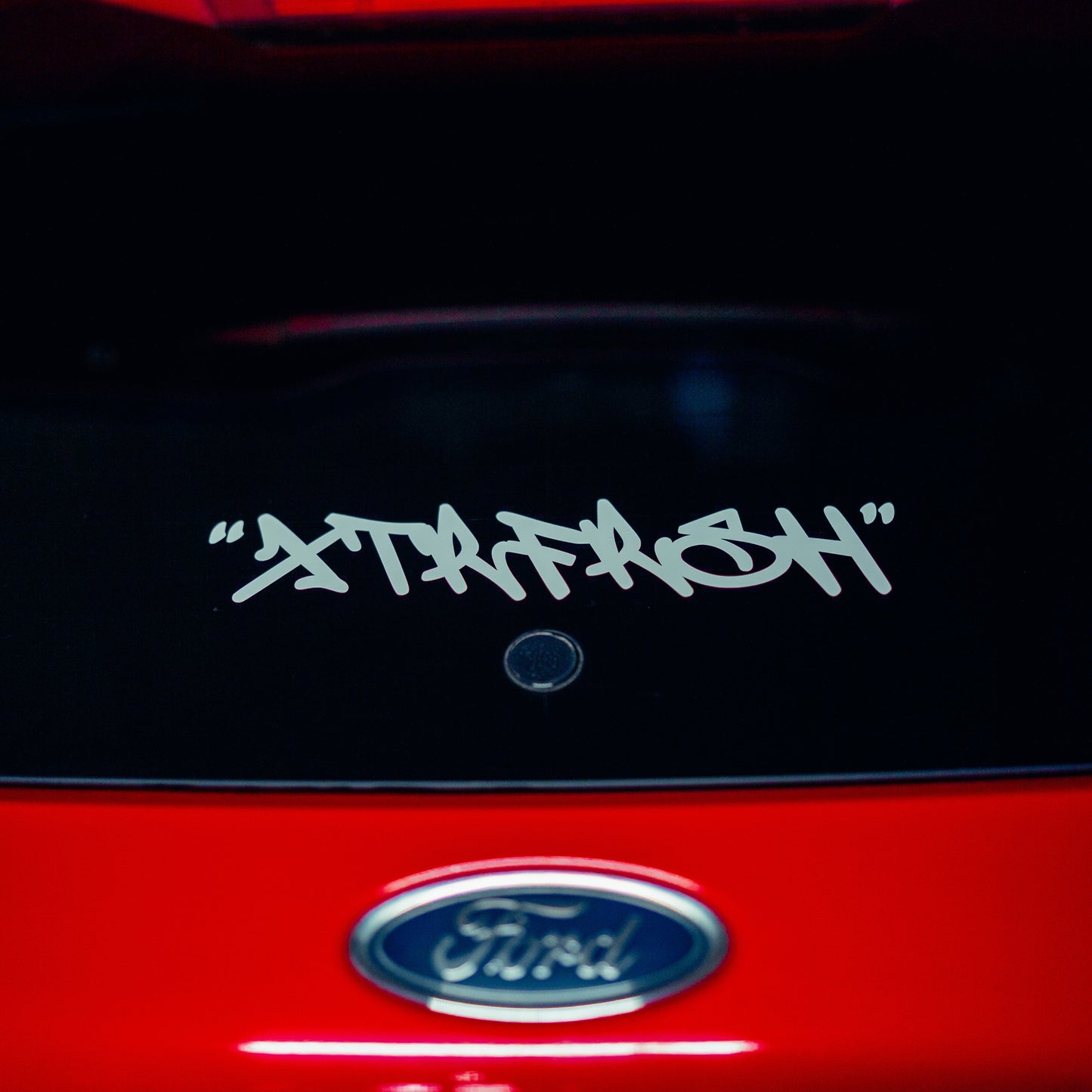 XTRFRSH grafitti sticker on a car window.