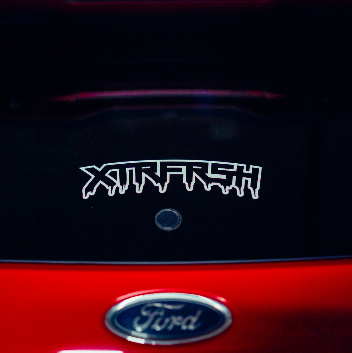 XTRFRSH OG drip sticker on a car window.