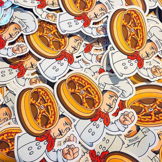 XTRFRSH pizza chef holding a wheel made out of pizza.