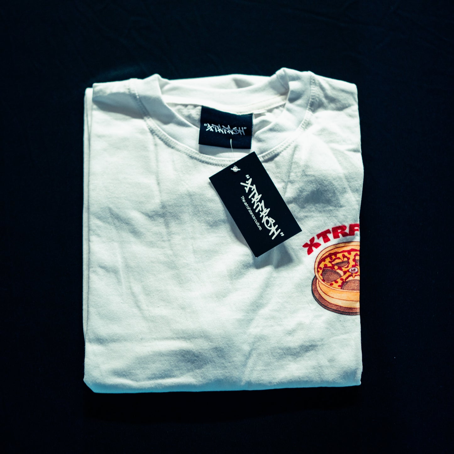 Folded up XTRFRSH Stance 'nd Slices t-shirt.