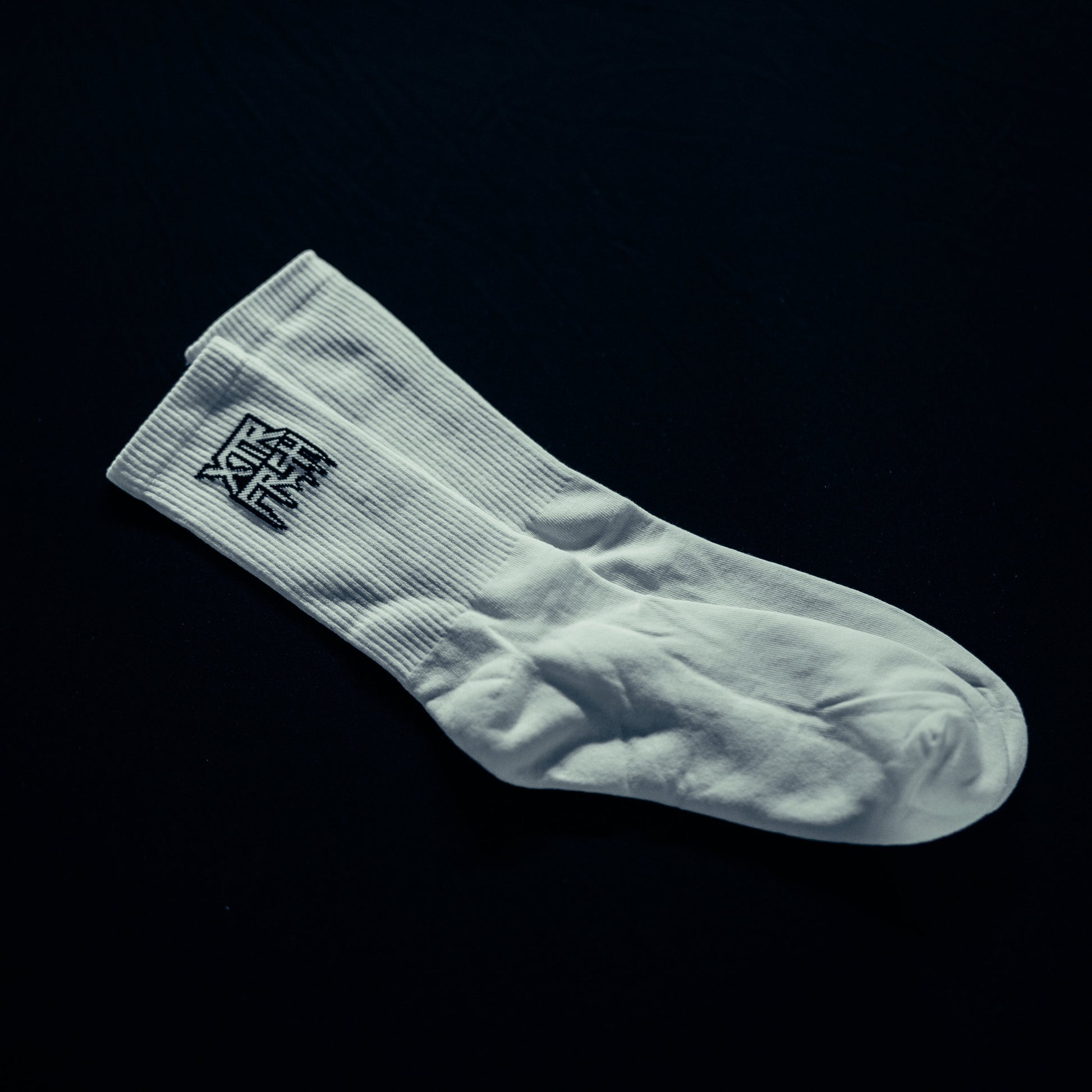 White socks with a black XTRFRSH logo.