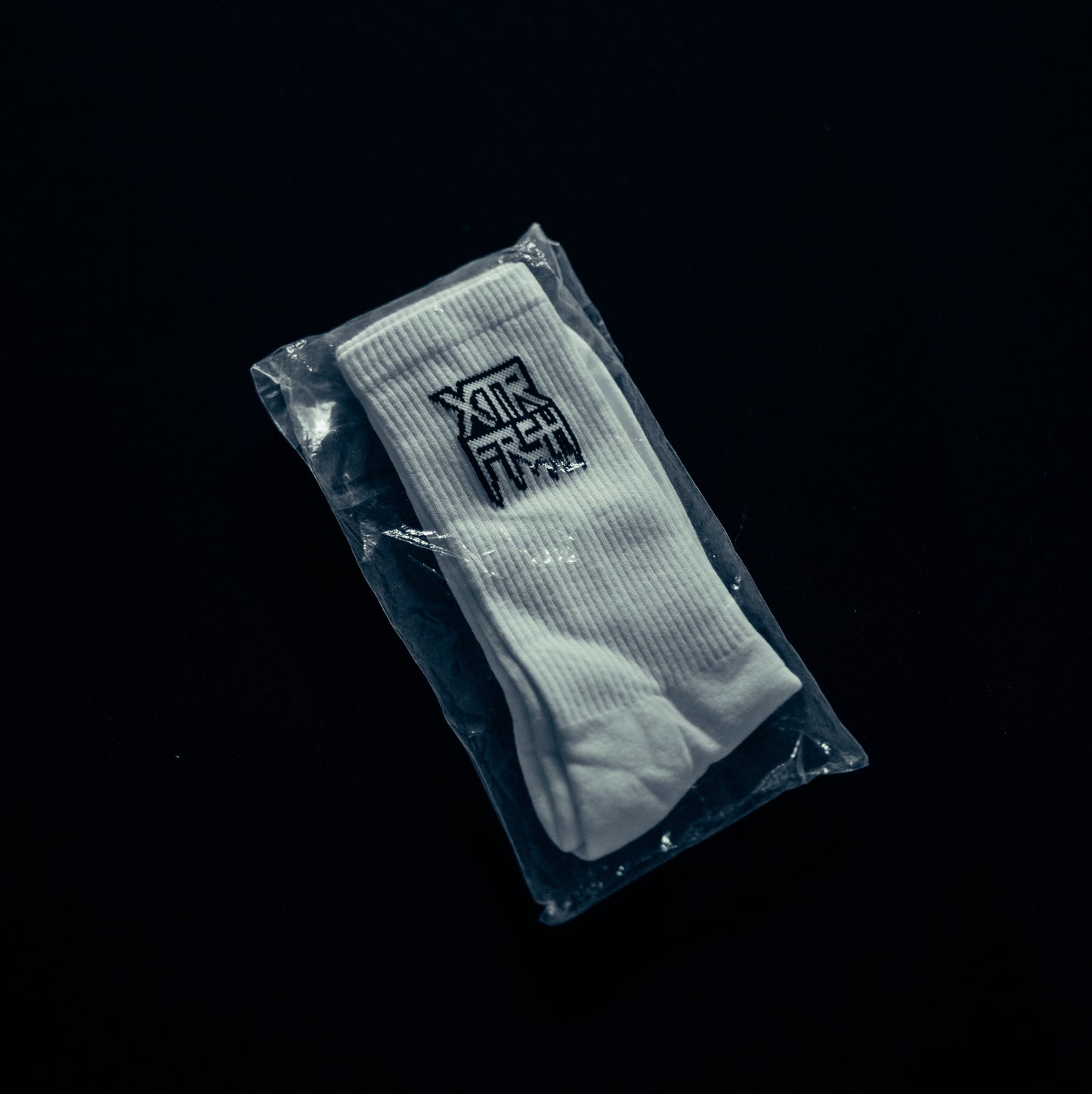 White socks with a black XTRFRSH logo.